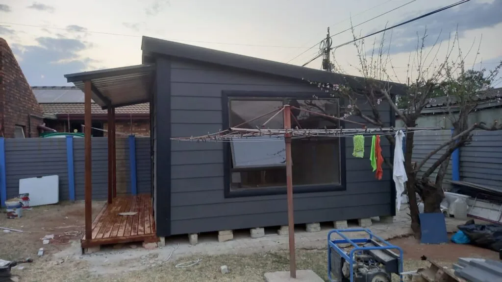 Wendy house and Nutec house used as a playroom and permanent residence